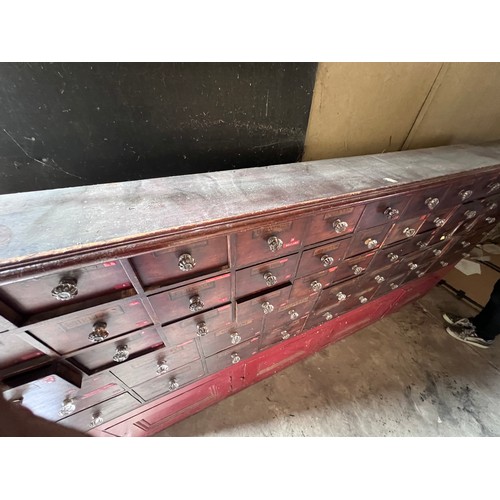 64 - Nineteenth century drug run/drawers, multiple drawers over cupboards to base. 268cm l x 137cm h x 30... 