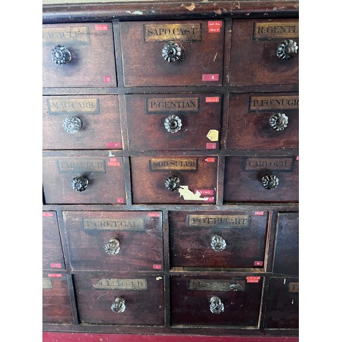 64 - Nineteenth century drug run/drawers, multiple drawers over cupboards to base. 268cm l x 137cm h x 30... 