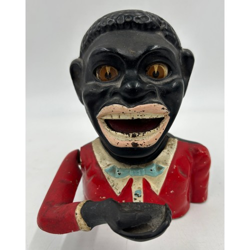 1368 - A vintage novelty greedy boy cast money box, in working condition. 15cm h.