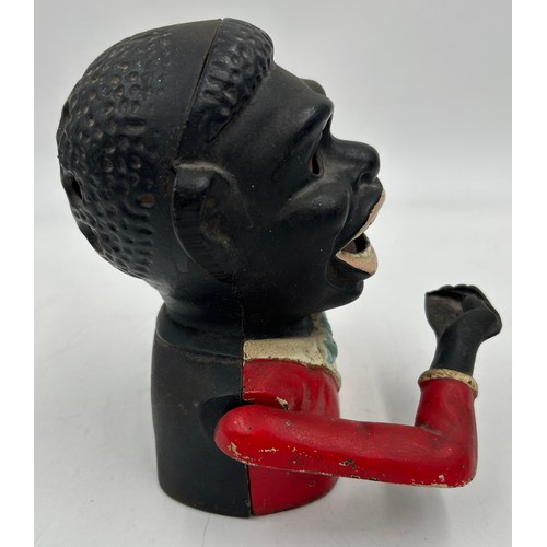 1368 - A vintage novelty greedy boy cast money box, in working condition. 15cm h.