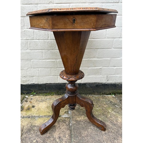 63 - A walnut trumpet work box on tripod legs. 43cm w x 75cm h.