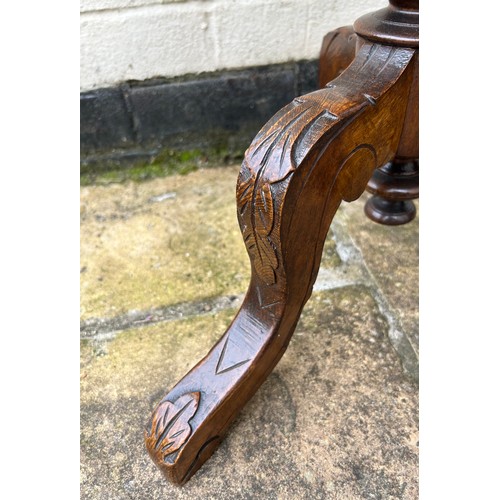 63 - A walnut trumpet work box on tripod legs. 43cm w x 75cm h.