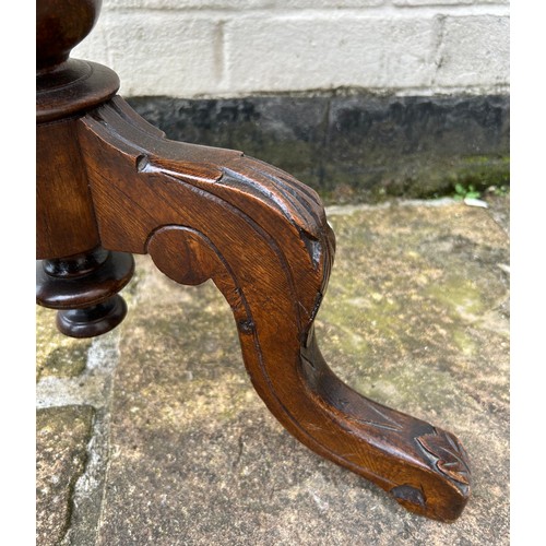 63 - A walnut trumpet work box on tripod legs. 43cm w x 75cm h.