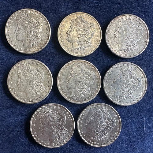 796 - A collection of eight United States of America Silver Dollars to include 1879, 1880, 1883, 1884 x 2,... 