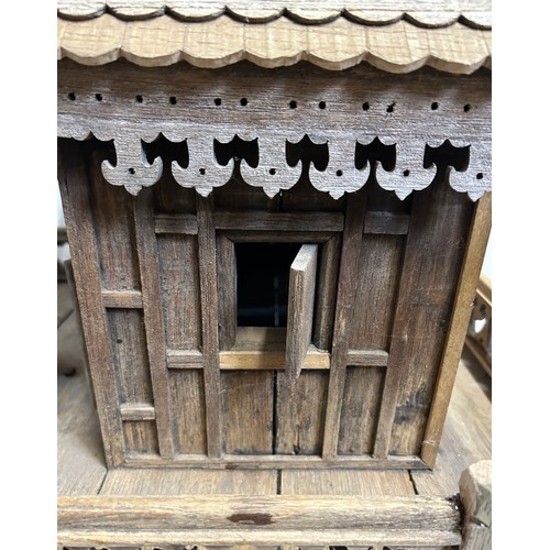 1372 - A vintage hand built wooden model of a Thai stilt house. 56cm h x 62cm x 60cm.