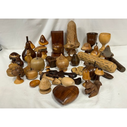 1373 - A collection of 20thC treen items to include toadstools, pears, apples, acorn, squirrel, hearts, lid... 