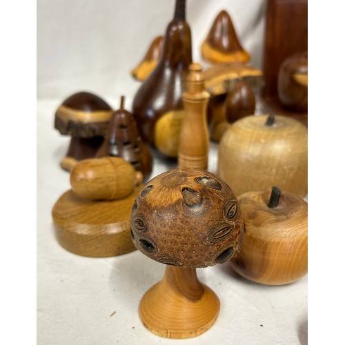 1373 - A collection of 20thC treen items to include toadstools, pears, apples, acorn, squirrel, hearts, lid... 