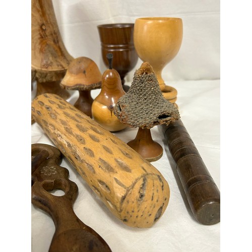 1373 - A collection of 20thC treen items to include toadstools, pears, apples, acorn, squirrel, hearts, lid... 