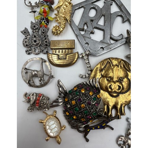 1374 - A quantity of costume jewellery to include silver rings, various brooches, a RAC car badge.