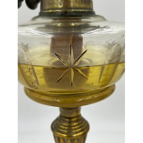 1130 - Two brass oil lamps. Lamp with shade approx. 60cm h.