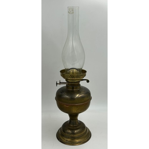 1130 - Two brass oil lamps. Lamp with shade approx. 60cm h.