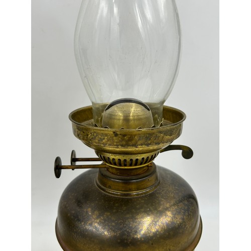 1130 - Two brass oil lamps. Lamp with shade approx. 60cm h.