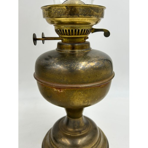 1130 - Two brass oil lamps. Lamp with shade approx. 60cm h.