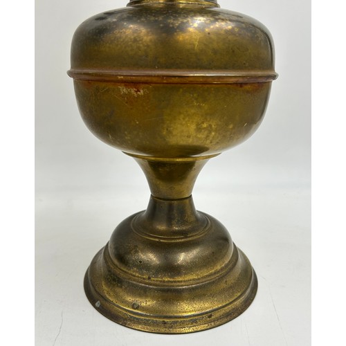 1130 - Two brass oil lamps. Lamp with shade approx. 60cm h.