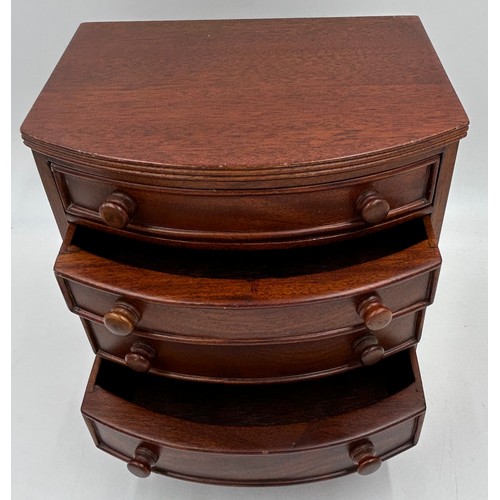 1066 - A miniature bow fronted mahogany jewellery chest with 4 drawers 23.5cm x 14cm to include an Italian ... 