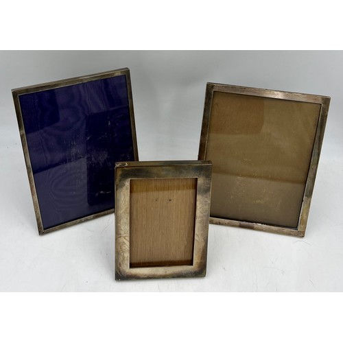 885 - Three hallmarked silver photograph frames.  17cm x 12.5 cm, Birmingham 1916, 22.5cm x 17.5cm Birming... 