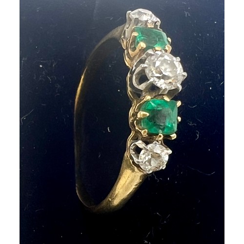 679 - An unmarked yellow and white metal ring set with green and clear stones. Size Q. Weight 2.7gm.