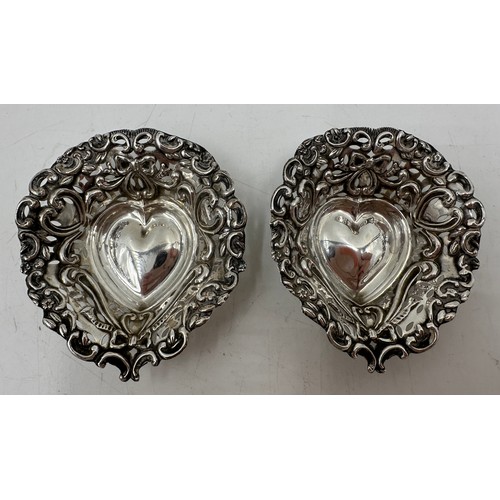 893 - A pair of hallmarked silver bon bon dishes, heart shaped with scrolls and  bows and pierced bodies. ... 