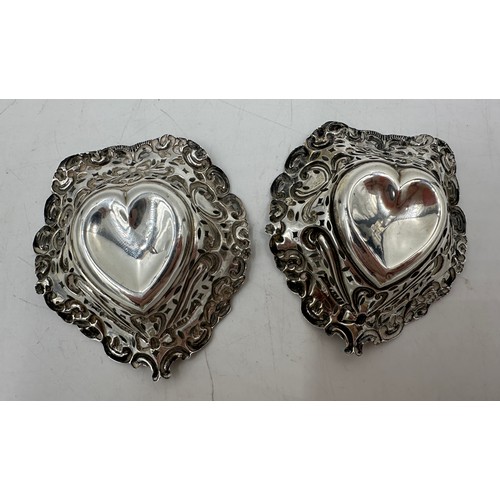 893 - A pair of hallmarked silver bon bon dishes, heart shaped with scrolls and  bows and pierced bodies. ... 