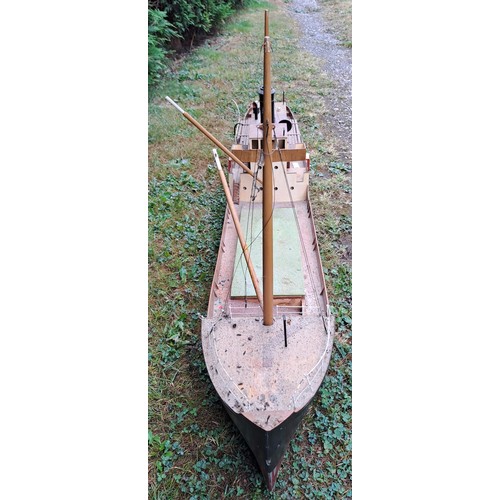 1295 - A vintage remote controlled boat with masts. 60cm h x 130cm w x 23cm d.