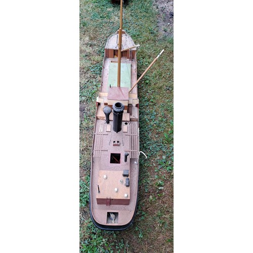 1295 - A vintage remote controlled boat with masts. 60cm h x 130cm w x 23cm d.