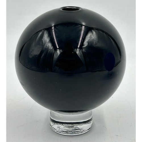 489 - Two Gillies Jones Rosedale glass ball vases, blue 14cm h, black 12cm h, each on a short clear glass ... 