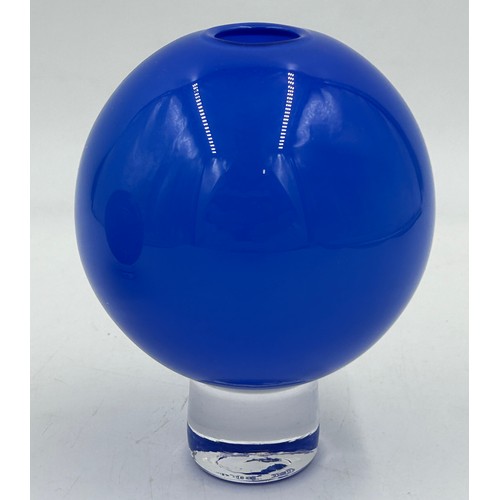 489 - Two Gillies Jones Rosedale glass ball vases, blue 14cm h, black 12cm h, each on a short clear glass ... 