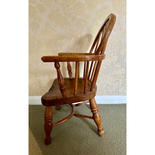 81 - A 19thC child’s windsor armchair with crinoline stretcher. Height to back 66cm, height to seat 26cm.... 