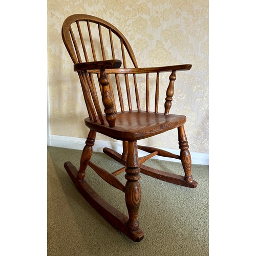 85 - Child’s windsor rocking armchair in ash and elm. Height to back 74cm 45.5cm w x height to seat 34cm.