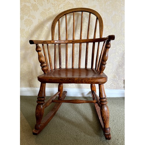 85 - Child’s windsor rocking armchair in ash and elm. Height to back 74cm 45.5cm w x height to seat 34cm.