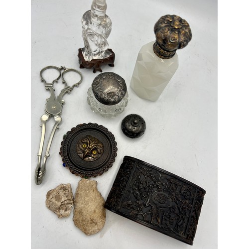 1391 - A miscellany to include 19thC white glass scent bottle, owl pin cushion, sugar nips, silver topped g... 