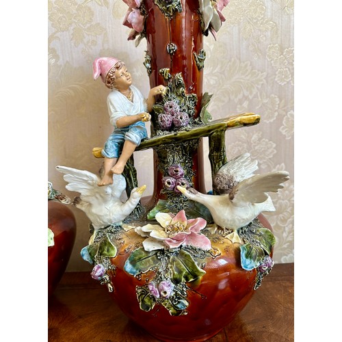 367 - A pair of 19thC continental vases with children, flowers and birds. 53cm h.