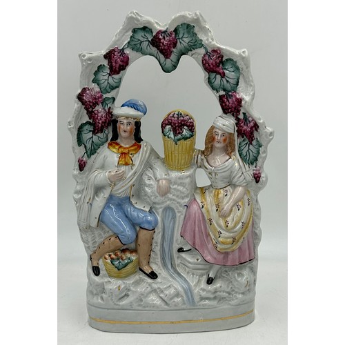 372 - A collection of Staffordshire figures to include The Lion Slayer 43cm, a couple under an arbour of v... 