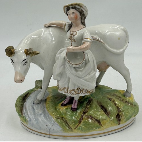 372 - A collection of Staffordshire figures to include The Lion Slayer 43cm, a couple under an arbour of v... 