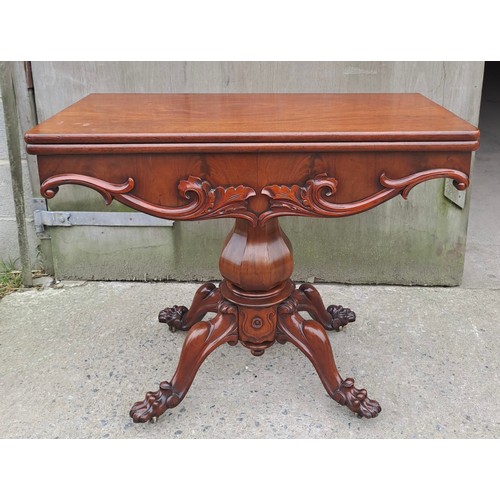 68 - A 19thC mahogany fold over tea table on pedestal base with paw feet on castors. Open 75cm h x 85cm w... 