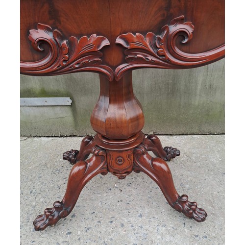 68 - A 19thC mahogany fold over tea table on pedestal base with paw feet on castors. Open 75cm h x 85cm w... 