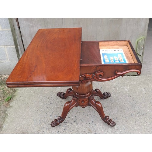 68 - A 19thC mahogany fold over tea table on pedestal base with paw feet on castors. Open 75cm h x 85cm w... 