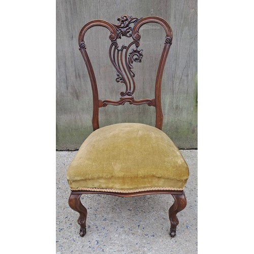 71 - A 19thC mahogany nursing chair with cabriole legs to front and decorative carved back. 86cm h x 49cm... 