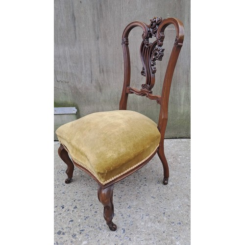 71 - A 19thC mahogany nursing chair with cabriole legs to front and decorative carved back. 86cm h x 49cm... 