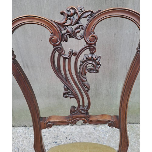 71 - A 19thC mahogany nursing chair with cabriole legs to front and decorative carved back. 86cm h x 49cm... 