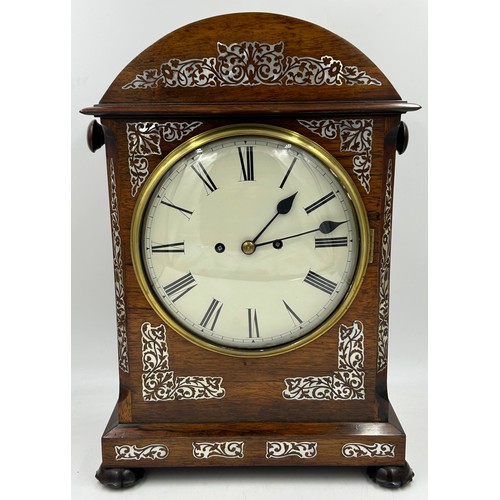 1122 - A Regency rosewood chiming bracket clock with mother of pearl inlay with brass fret work panels to e... 