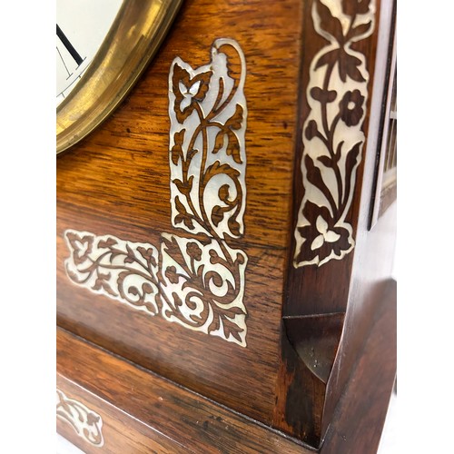 1122 - A Regency rosewood chiming bracket clock with mother of pearl inlay with brass fret work panels to e... 