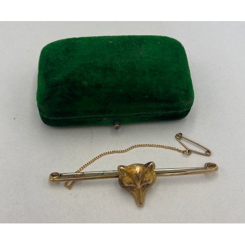 651 - Two 15 carat gold bar brooches to include fox mask, both set with clear stones. Total weight 6.6gm.