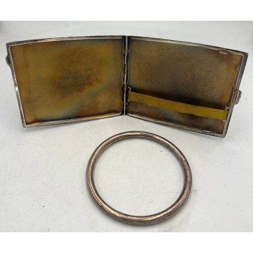 912 - Silver cigarette case Birmingham 1946, together with a silver bangle Birmingham 1922. Total weight 1... 