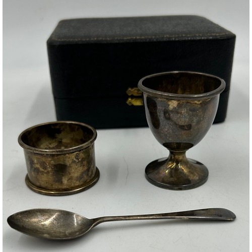 904 - A hallmarked cased silver christening set consisting of egg cup, spoon and napkin ring, Adie Brother... 