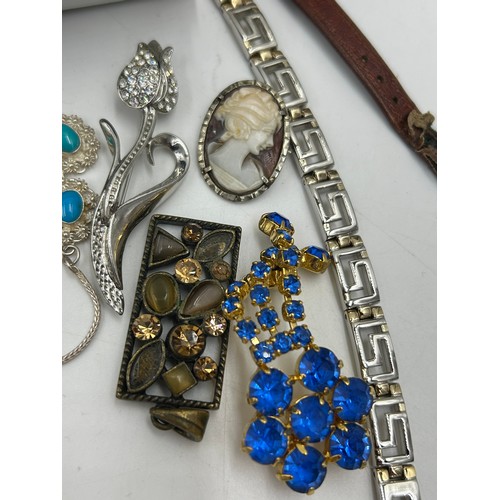 516 - A quantity of costume jewellery to include  brooches, earrings, necklaces, a Michael Kors watch with... 