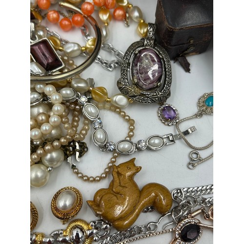 516 - A quantity of costume jewellery to include  brooches, earrings, necklaces, a Michael Kors watch with... 