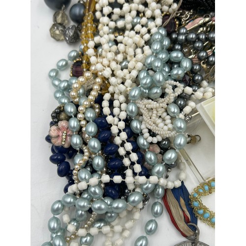 516 - A quantity of costume jewellery to include  brooches, earrings, necklaces, a Michael Kors watch with... 