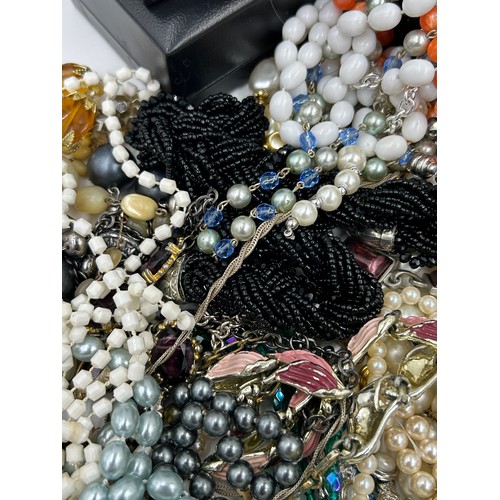 516 - A quantity of costume jewellery to include  brooches, earrings, necklaces, a Michael Kors watch with... 