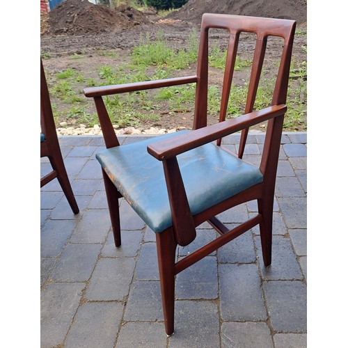 98 - A mid 20thC teak extending dining table and six chairs including two with arms. Table size open 69cm... 